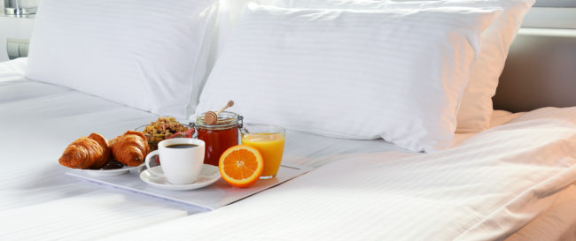 Breakfast in bed in hotel room. Accommodation.